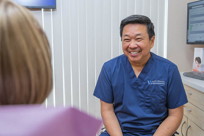 Dr. Doug Wong smiles to a patient